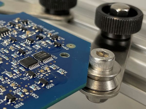 Circuit boards can be placed on the top rim of the Edge Clamps for rapid processing.